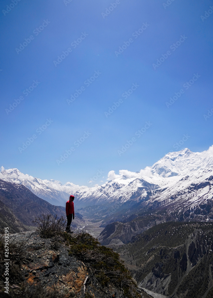 Explorer concept: Copyspace of man standing on the edge of a clift in Annapurna Circuit Explorer concept: Copyspace of man standing on the edge of a clift in Annapurna Circuit