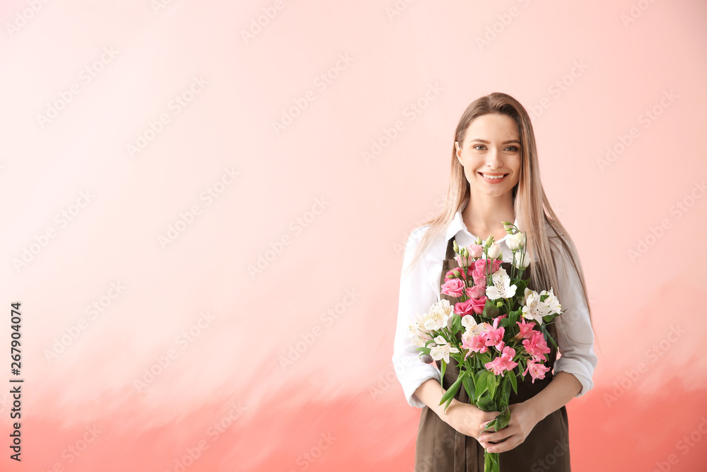 Young female florist with bouquet on color background