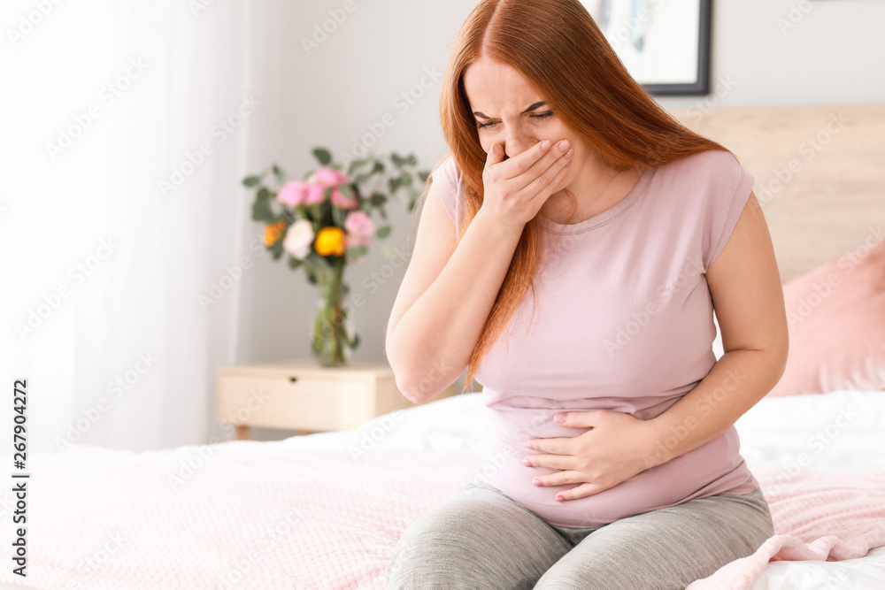 Young pregnant woman suffering from toxicosis at home Young pregnant woman suffering from toxicosis at home