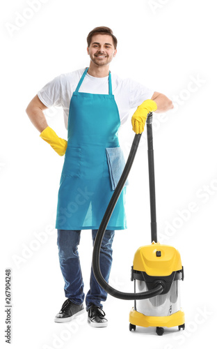 Male janitor with vacuum cleaner on white background photo