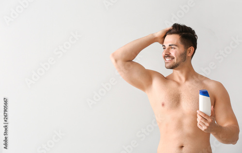 Handsome man with bottle of...