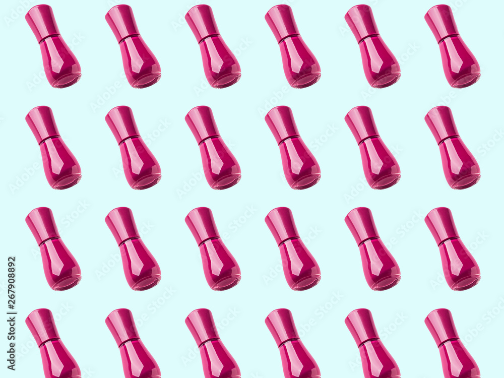 Dark pink nail polish bottle pattern isolated on mint green Dark pink nail polish bottle pattern isolated on mint green