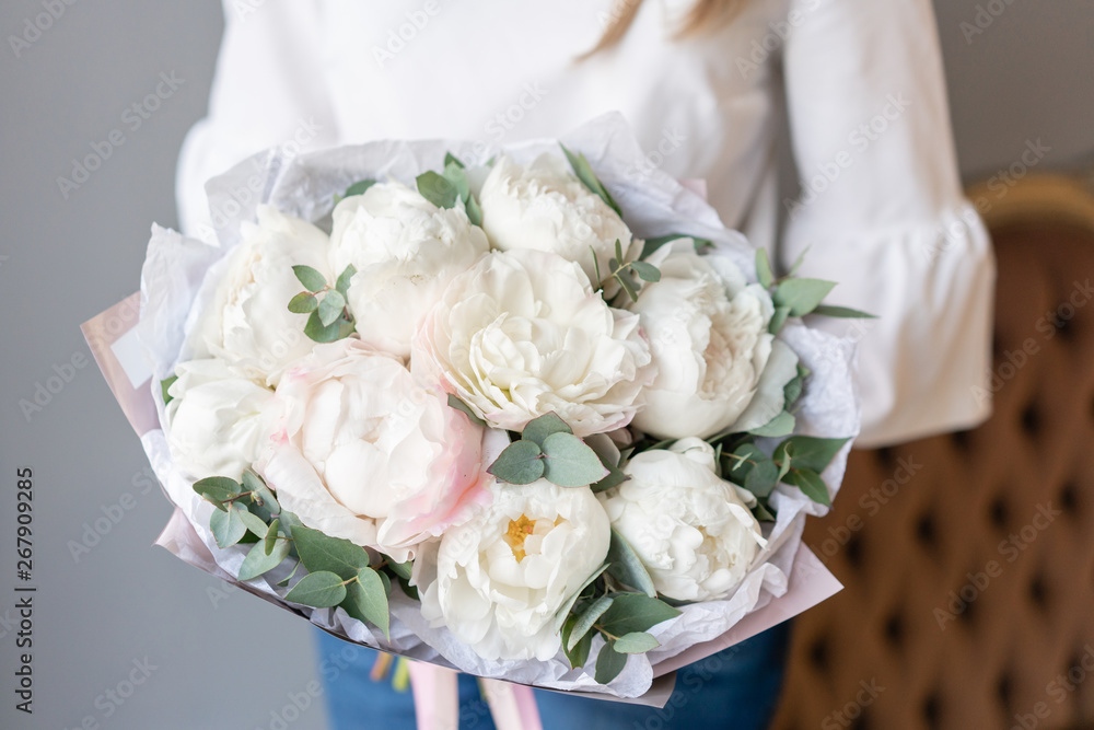 White peonies with eucalyptus in womans hand. Beautiful peony flower for catalog or online store. Beautiful bouquet. Floral shop concept . Fresh cut Flowers delivery White peonies with eucalyptus in womans hand. Beautiful peony flower for catalog or online store. Beautiful bouquet. Floral shop concept . Fresh cut Flowers delivery
