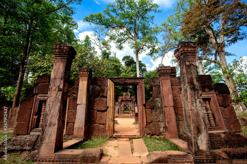The path through the ancient Khmer castle gate in Angkor Wat Siem Reap in Cambodia in a cloudy cloud in the blue sky.