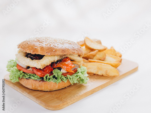 Big tasty burger on background on the wooden table