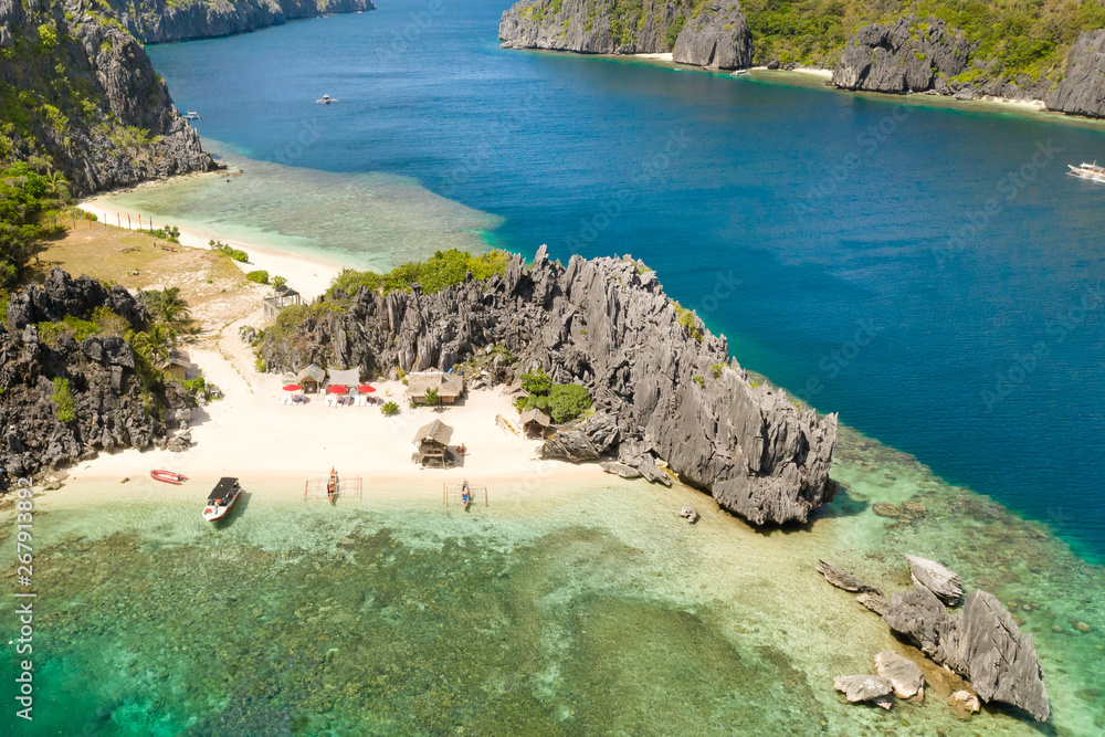 El Nido Palawan National Park Philippines. Warm hidden lagoon near the rocks. Tropical island with rocky shore and white beach. Tourist routes by boat.
