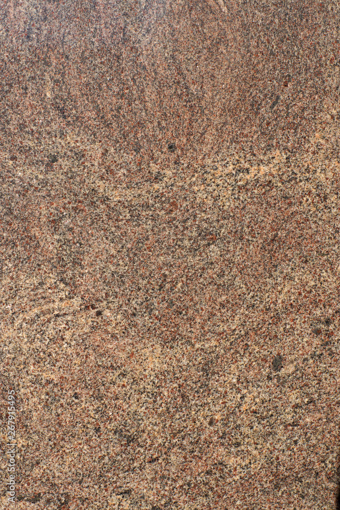 Natural stone brown granite with small red and light specks Natural stone brown granite with small red and light specks