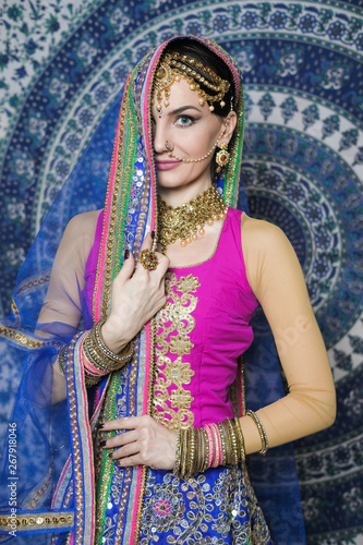 Portrait of a female model in ethnic indian costume with jewellery and traditional makeup.