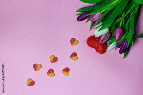Beautiful bouquet of purple tulips on pink background