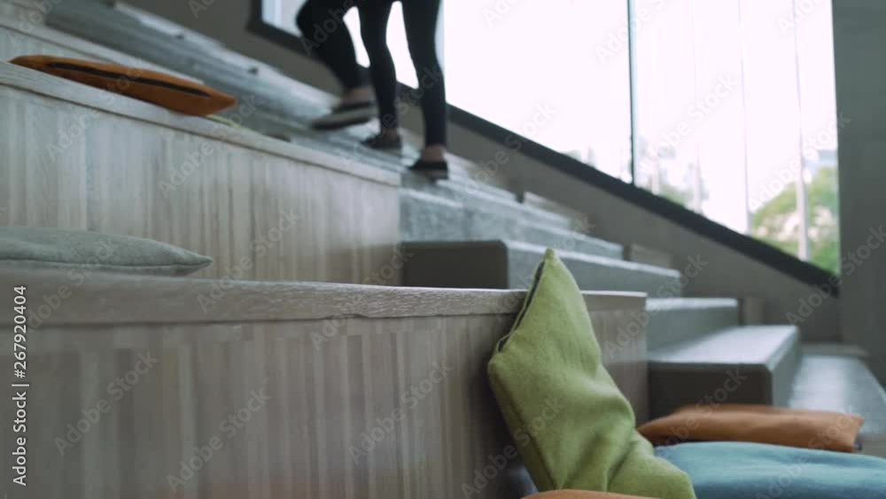 Two student girls climbing upstairs in school