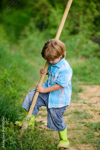 ecology and environmental protection. earth day. farming equipment. summer fun. happy child gardener. spring country side village. little kid having fun. nature and human. small kid use shovel