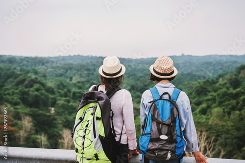 two asian woman tourist looking view forest on mountian. travel in holiday concept