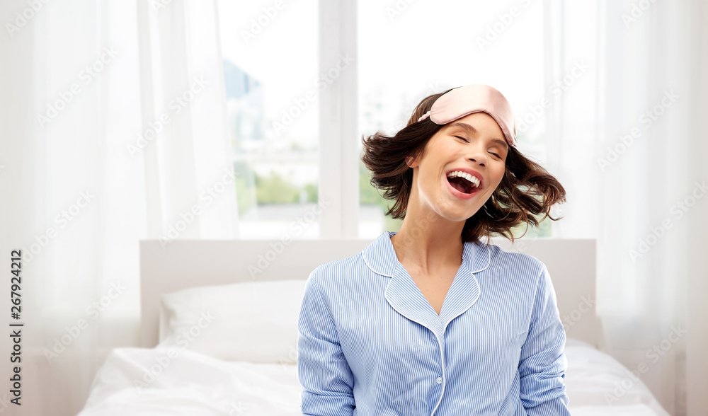 people and bedtime concept - happy young woman in pajama and eye sleeping mask over background people and bedtime concept - happy young woman in pajama and eye sleeping mask over background