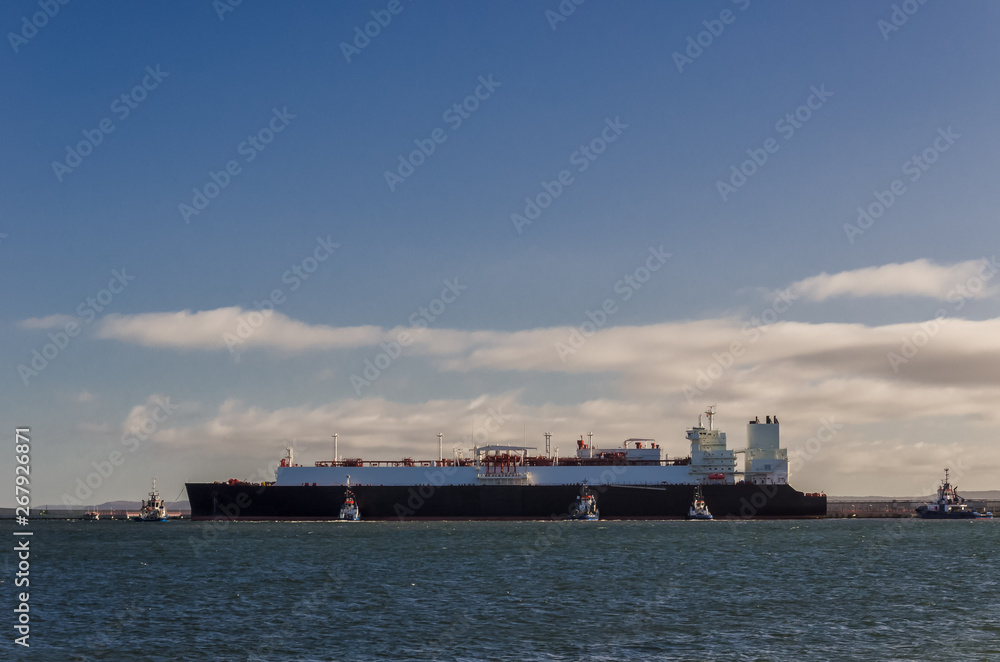 LNG TANKER - Ship and tugs are maneuvering at the gas terminal in Swinoujscie