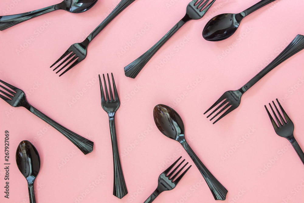 Fototapeta premium Forks and spoons on a pink background. Minimal concept.