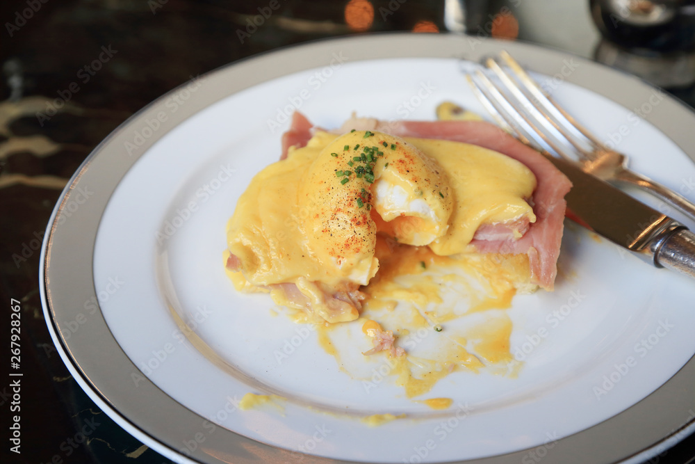 Egg Benedict with ham on white dish, English breakfast. Egg Benedict with ham on white dish, English breakfast.