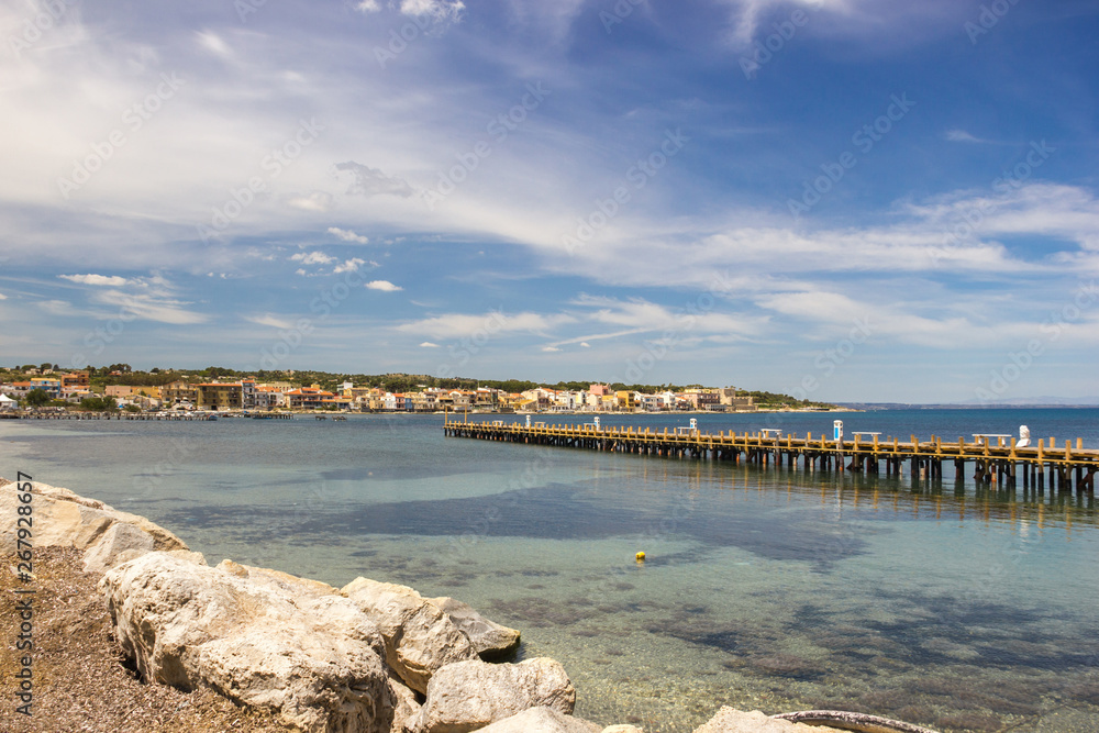 Brucoli view of the bay, the pier and the village in background in a sunny day