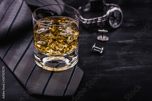 Male concept for father's day. Tie, watches, cufflinks and a glass of whiskey with ice