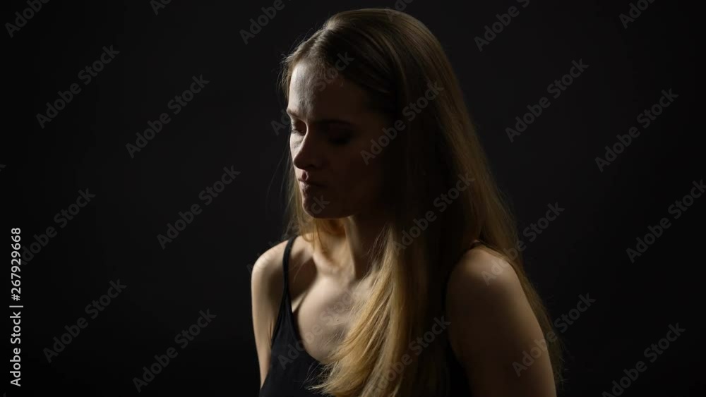 Angry woman squeezing red rose, conflict with boyfriend, break up concept