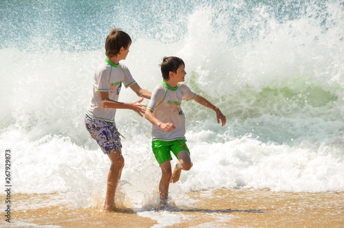 Children playing with waves 