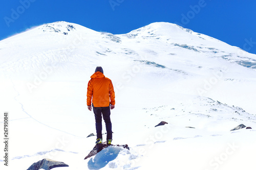 A man makes the approach under the mountain Elbrus. North Caucasus. Russia