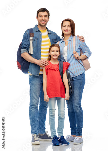family, tourism and travel concept - happy smiling mother, father and little daughter with backpacks over white background