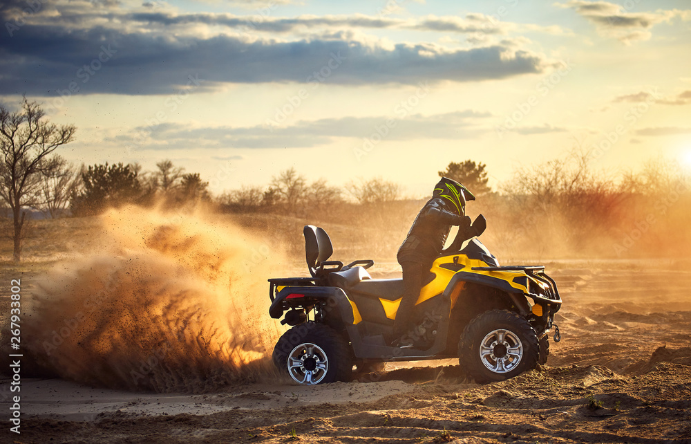 Racing powerful quad bike on the difficult sand in the summer. Racing powerful quad bike on the difficult sand in the summer.