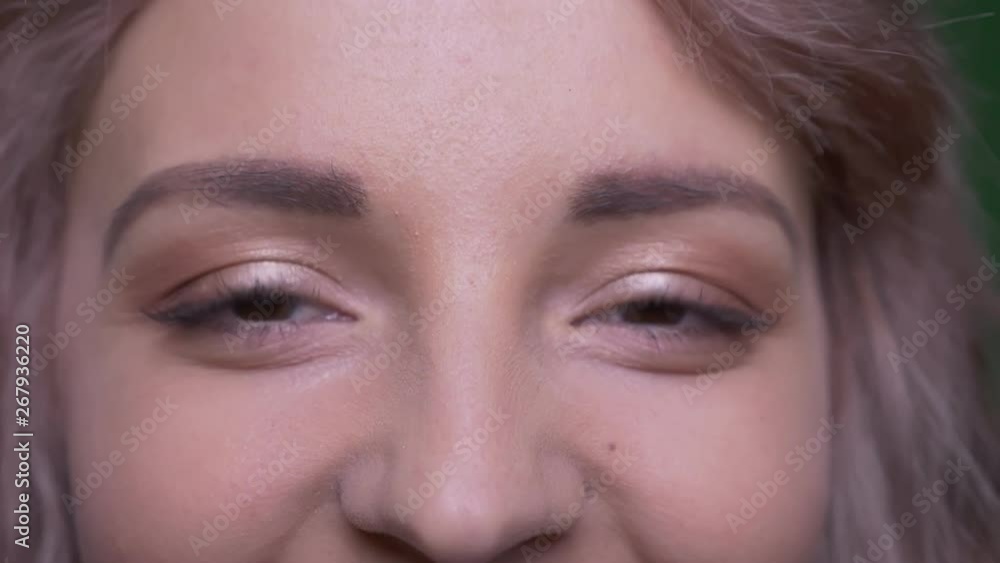 Close-up eye-portrait of pretty model smiling sincerely and happily into camera. Close-up eye-portrait of pretty model smiling sincerely and happily into camera.