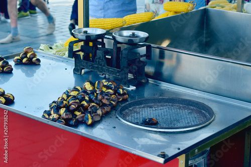 street food roasted chestnuts on a red vintage cart  fragment