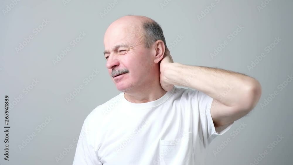 man holding hand on his neck suffering from pain man holding hand on his neck suffering from pain