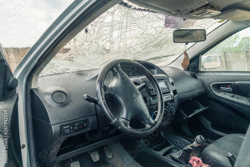 View of the inside of the car with cracks on the windshield due to damage due to an accident. © yaroslav1986