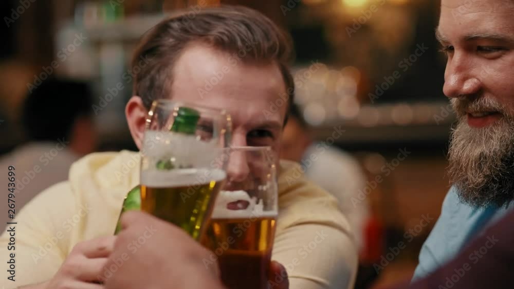 Men chilling with drinks in the pub Men chilling with drinks in the pub