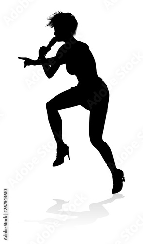 A woman singer pop, country music, rock star or even hiphop rapper artist vocalist singing in silhouette