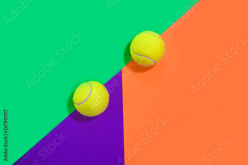 Tennis layout with tennis balls on abstract different multicolored neon background with place for text. Sport concept with tennis play. Flat lay, top view, selective focus. © IrynaV