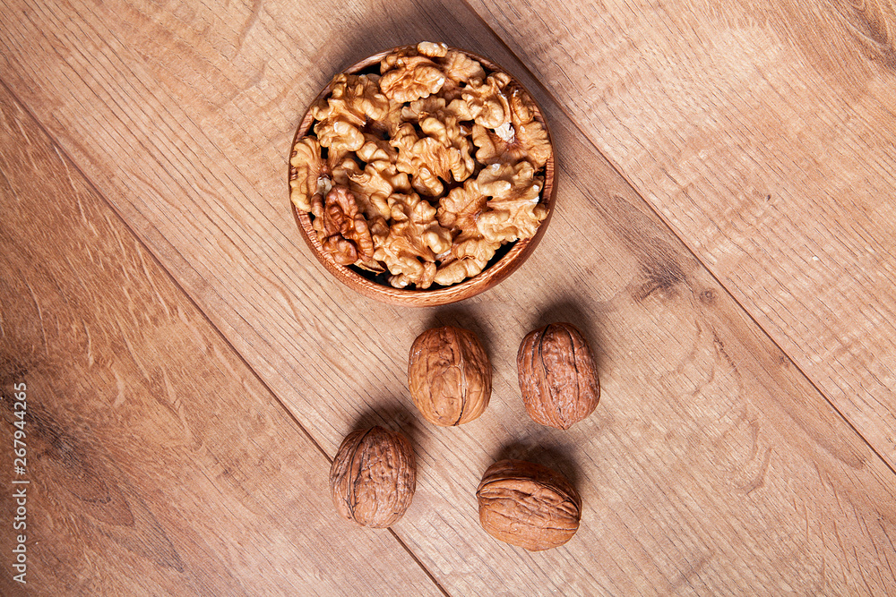 Walnut in a bowls on wooden table. Healthy food and snack. Walnut in a bowls on wooden table. Healthy food and snack.