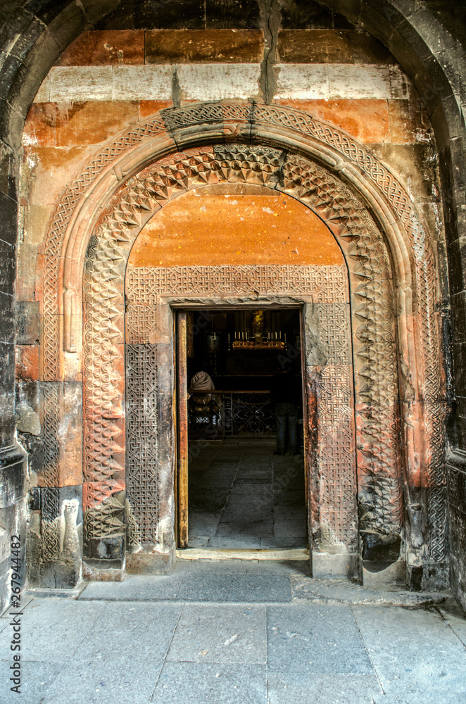 Entrance to the Church of the Holy Virgin in the frame of carved ethnic ornament along the arched cornice above the doorway in the fortresse Khor Virap