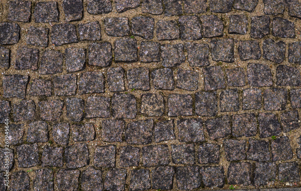 The texture of the pavement of granite paving stones. The texture of the pavement of granite paving stones.