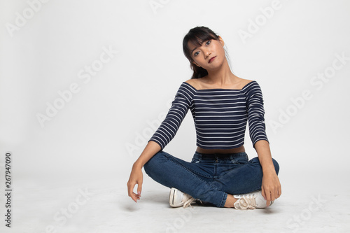 Full body of beautiful young Asian woman sit on floor