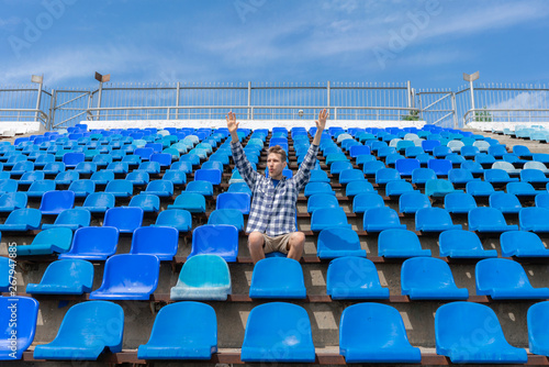 lonely man on the empty stadium seat cheering for the team, one man army concepts