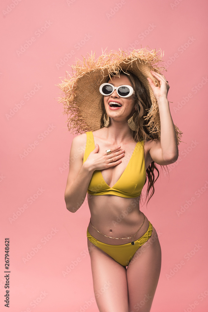 charming girl in straw hat and sunglasses smiling isolated on pink charming girl in straw hat and sunglasses smiling isolated on pink