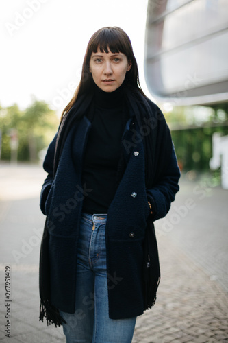 portrait of brunette woman with hands in the pockets of her coat © kay fochtmann