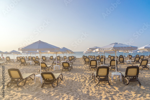 Chairs and umbrellas on a beautiful beach at sunrise in Sunny Beach on the Black Sea coast of Bulgaria