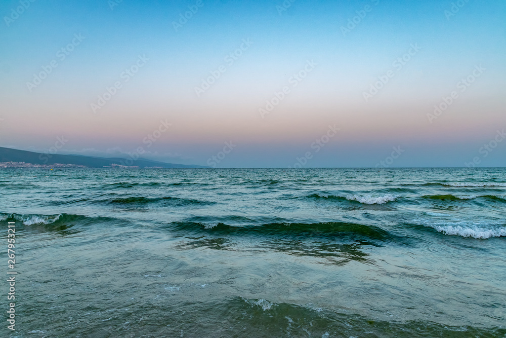 Waves at the beach at sunset in Sunny Beach on the Black Sea coast of Bulgaria