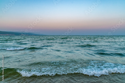 Waves at the beach at sunset in Sunny Beach on the Black Sea coast of Bulgaria