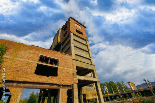 Karabash. Old ruined building, red brick factory, bottom view of blue sky. Horizontal photography photo