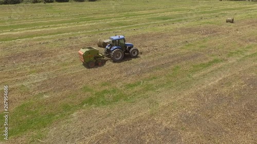13bird eye of Man at work on the tractor with hay baler