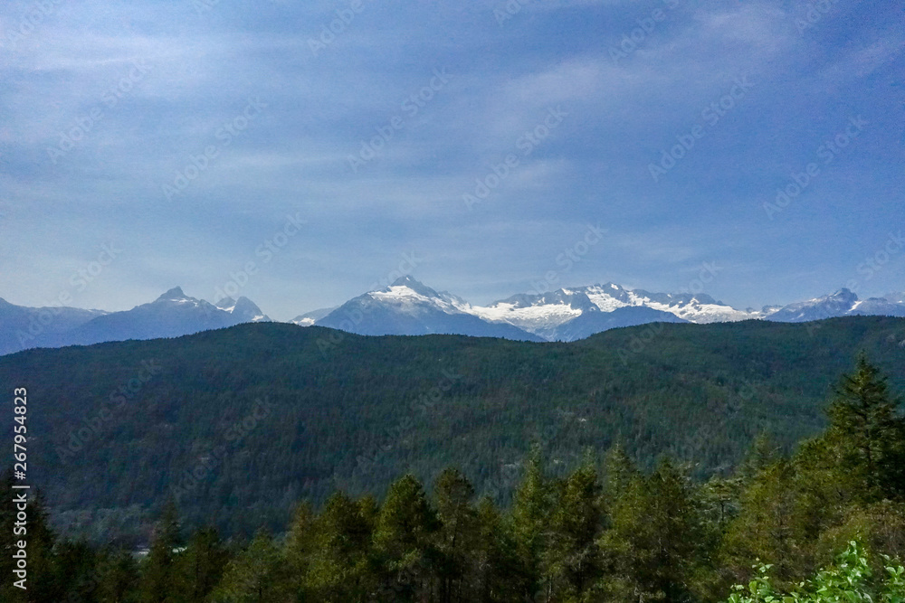 Panoramic view of the mountains with snow on top.