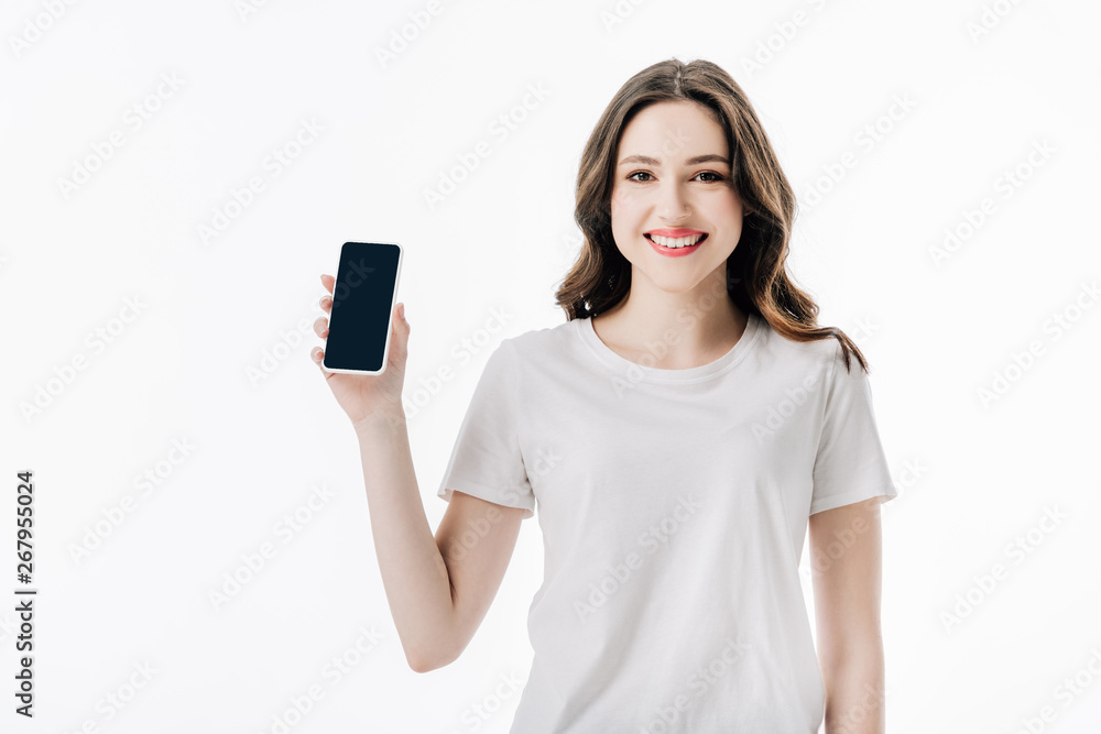 beautiful cheerful girl in white t-shirt holding smartphone with blank screen and looking at camera isolated on white beautiful cheerful girl in white t-shirt holding smartphone with blank screen and looking at camera isolated on white
