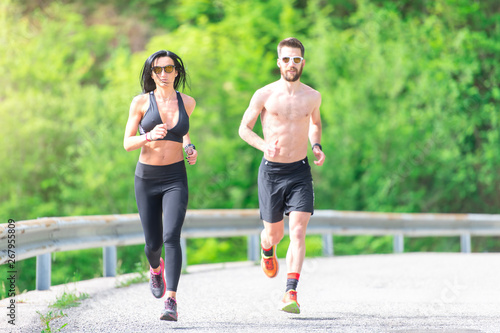 Woman with sports body during a race on her personal trainer