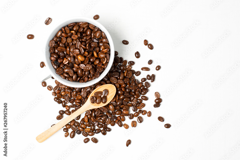 A cup of coffee and roasted coffee beans on white wood background A cup of coffee and roasted coffee beans on white wood background